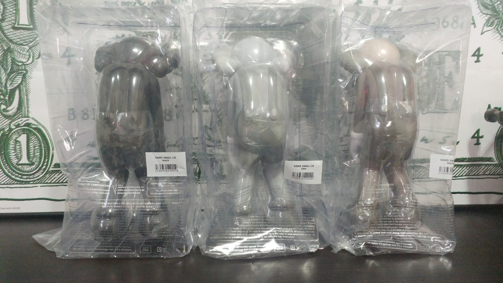 Kaws Small Lie Vinyl Figures - Set of 3 - Black, Grey and Brown