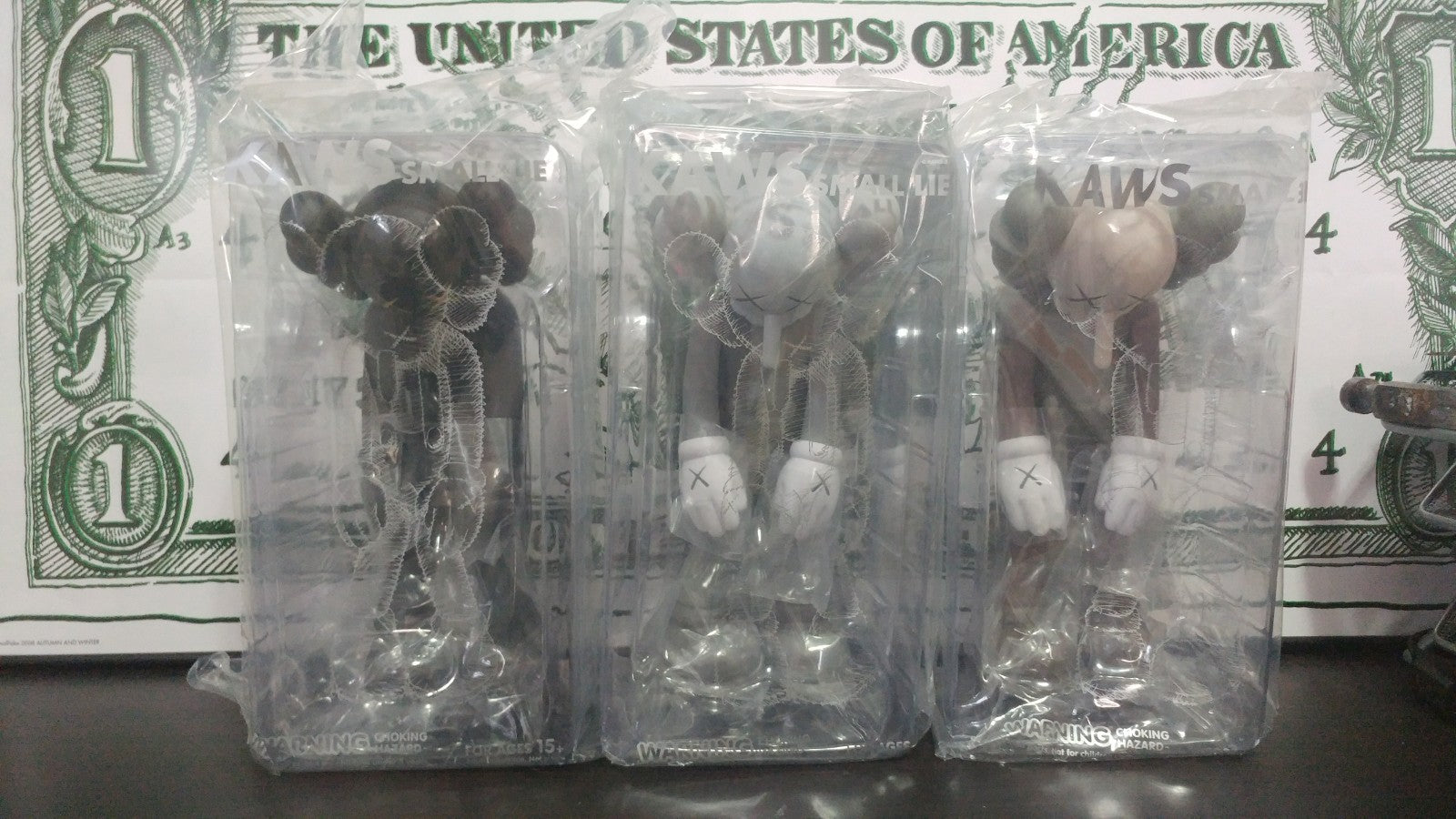 Kaws Small Lie Vinyl Figures - Set of 3 - Black, Grey and Brown